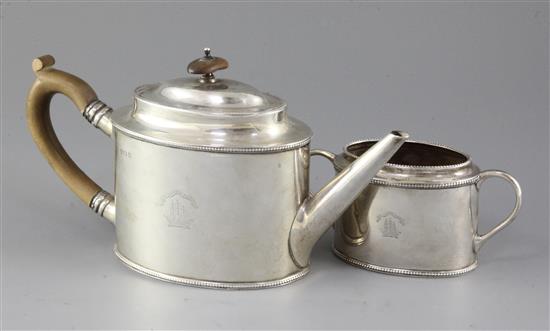 A George V silver oval teapot and matching sugar bowl engraved with latin motto Make For The Shore above a ship, gross 22.5 oz.